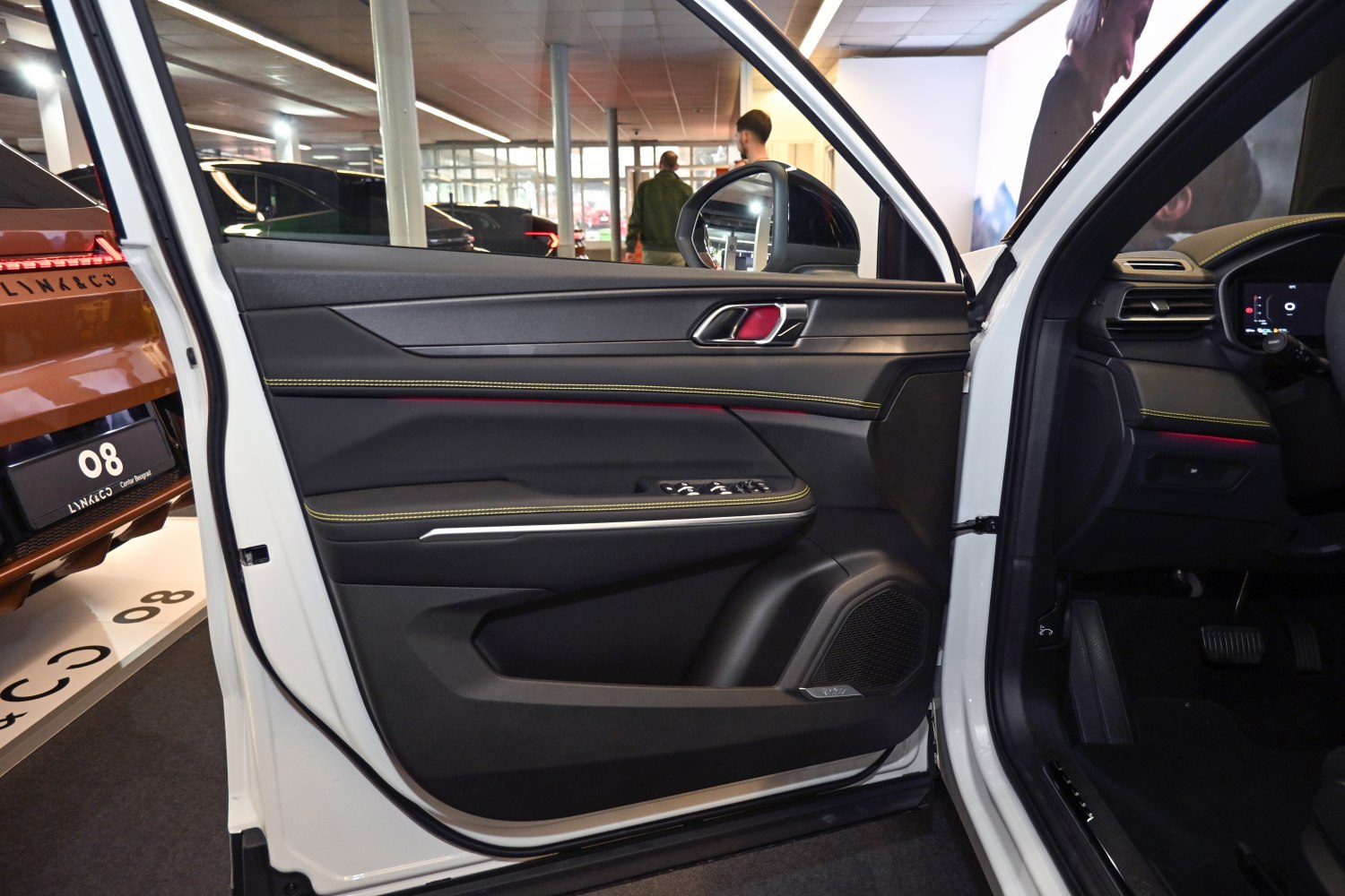 Interior door panel with yellow stitching and control switches