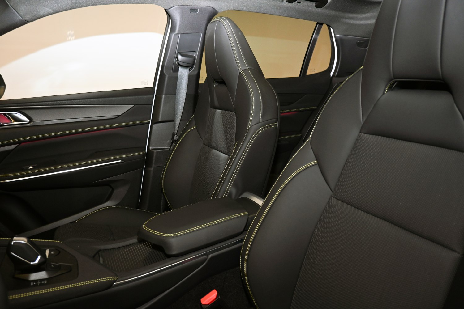 Black leather seats with yellow stitching and mid-console