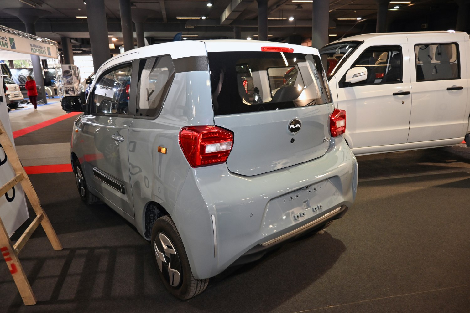 Rear view of compact electric microcar featuring tail lights and modern design.