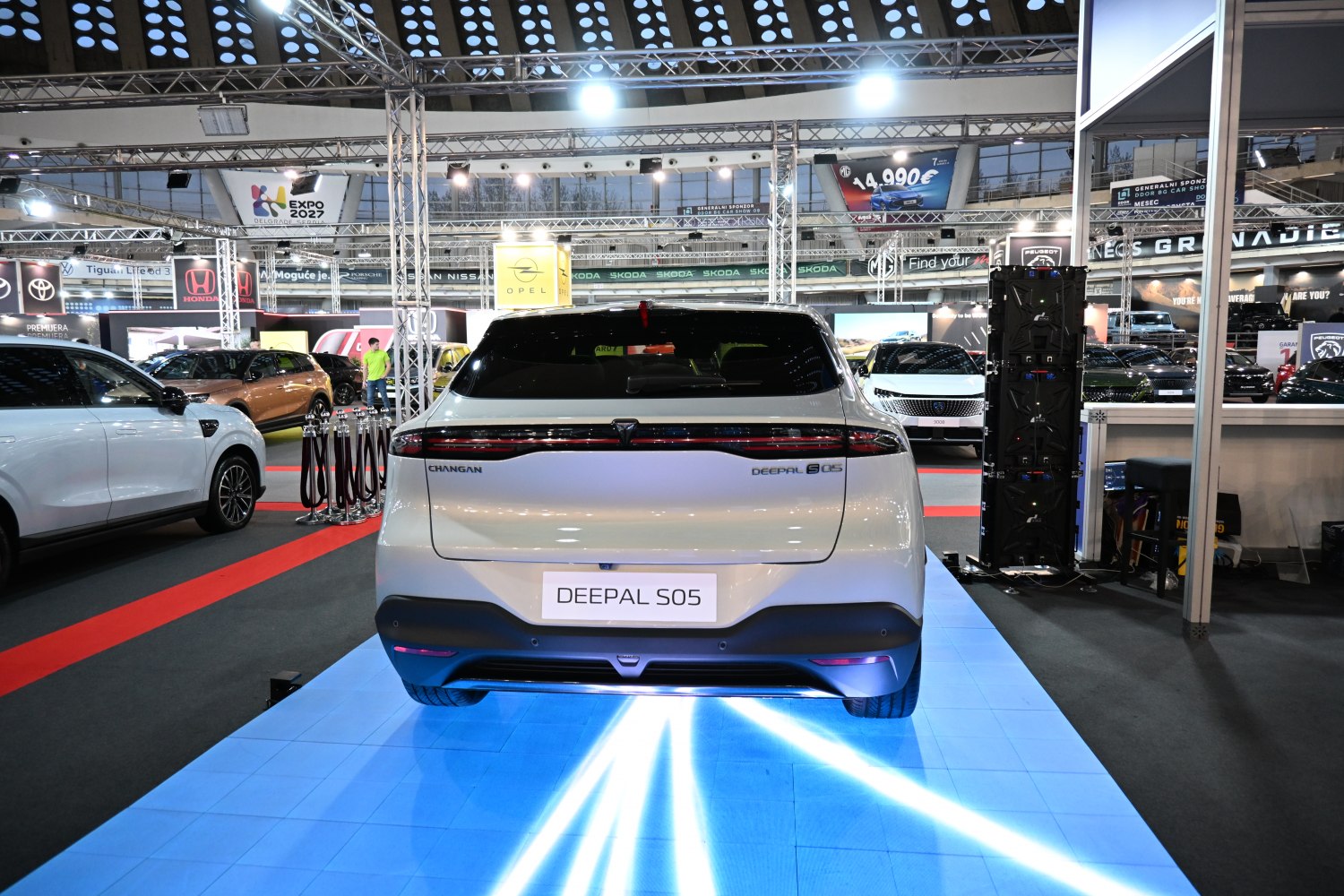 Rear view of a 2025 SUV with sleek continuous taillight strip and hatchback design