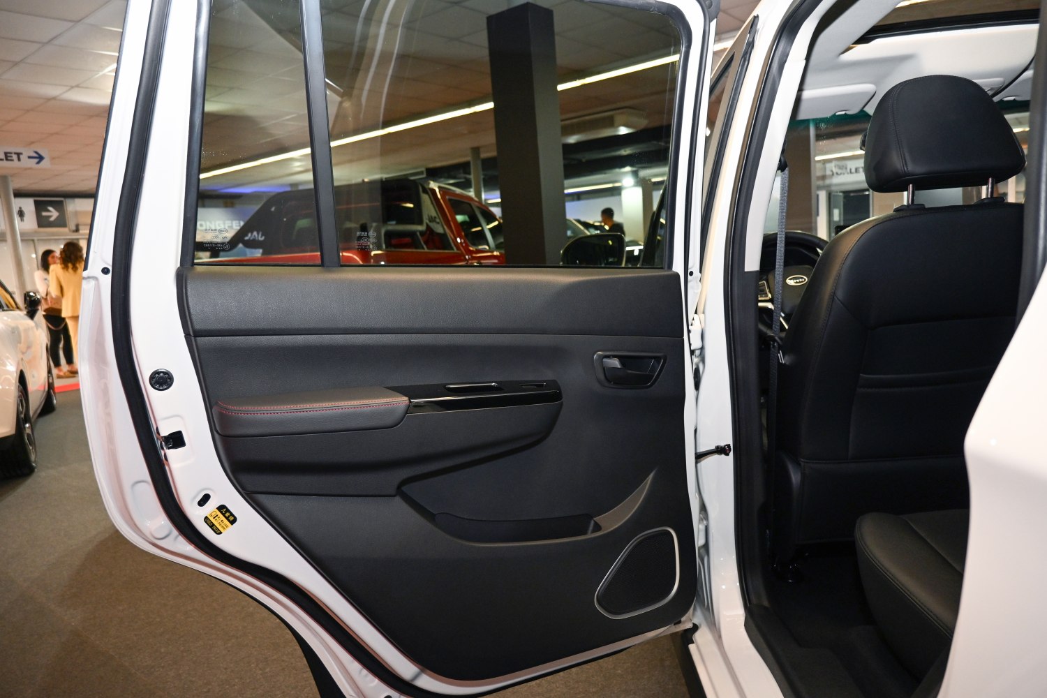 Rear door interior panel with handle, storage, and speaker