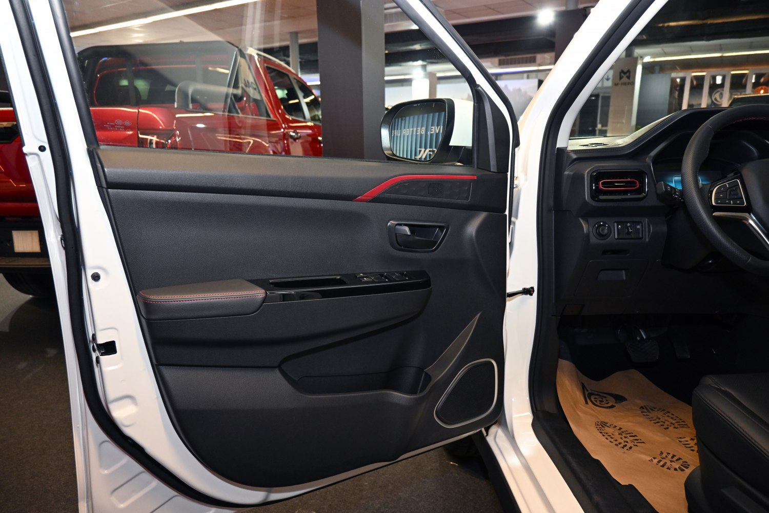 Car interior door panel with red trim and window control buttons