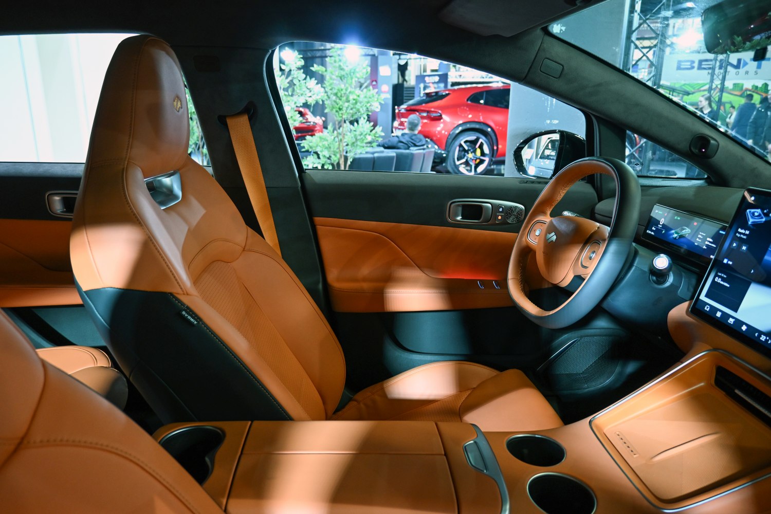 Tan leather seating and premium digital dashboard with infotainment screens
