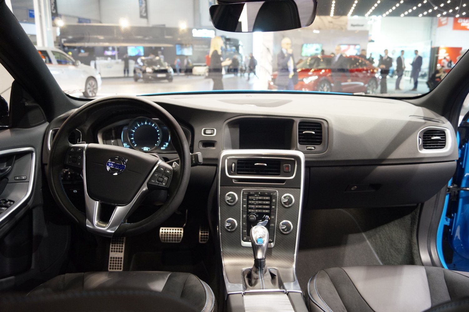 Dashboard, steering wheel, and center console view with digital instruments and gear shifter