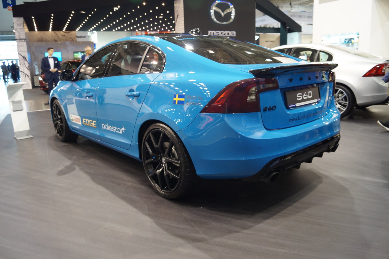 Blue sedan with black wheels and rear spoiler