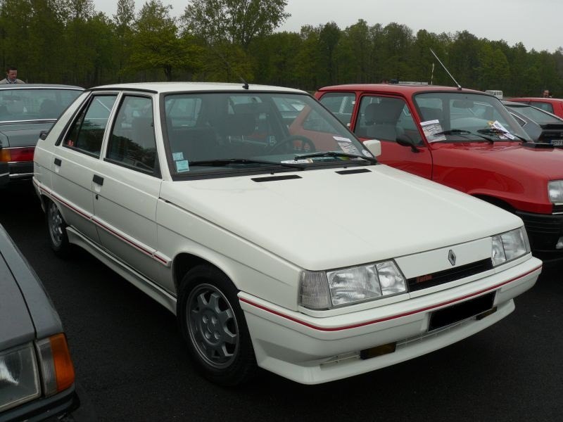 Angular white hatchback with rectangular headlights and a detailed side profile.