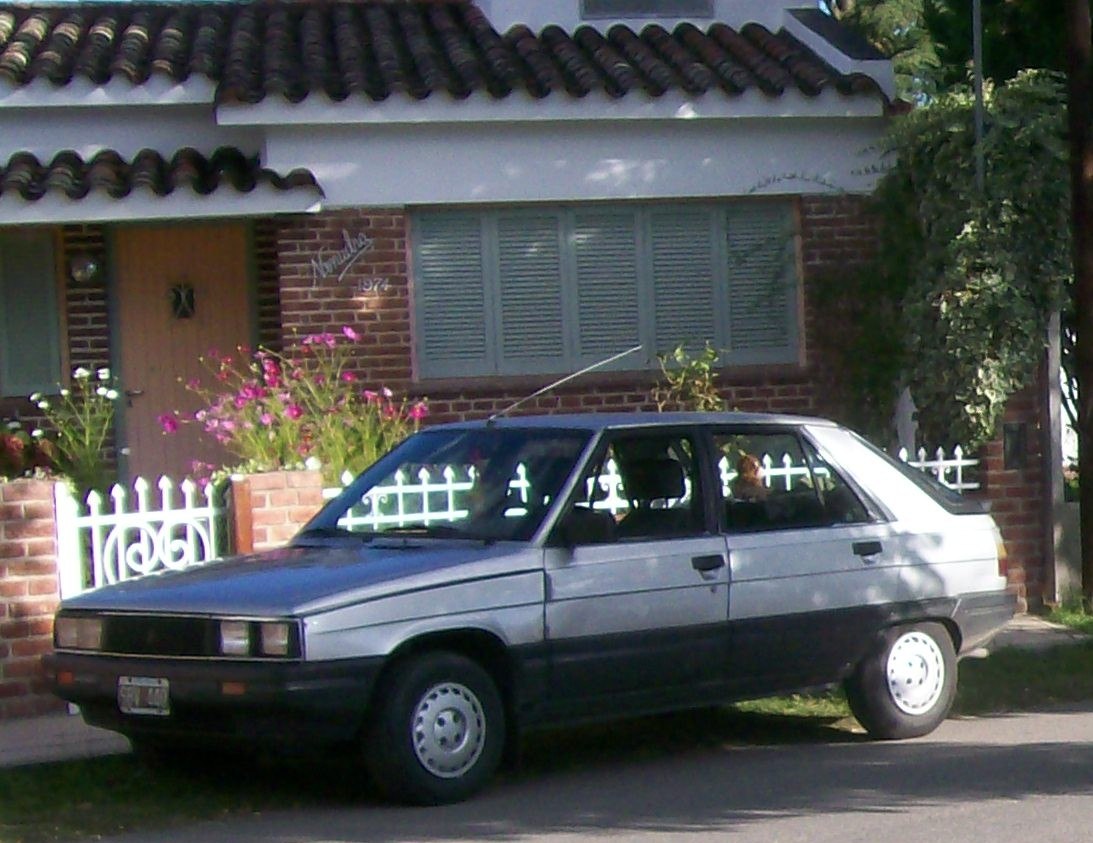 Silver black two-tone hatchback side view parked outdoors