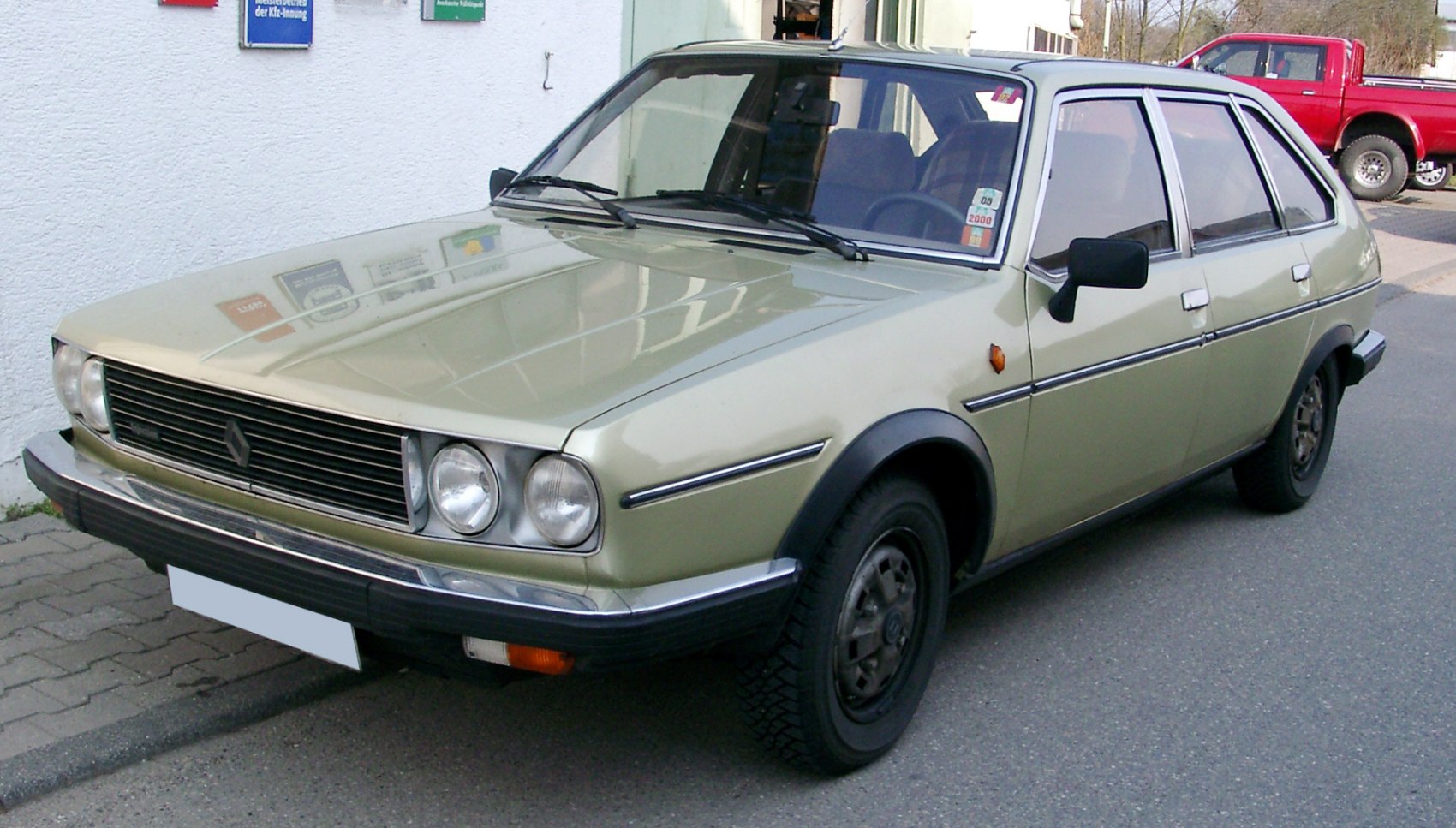 Retro hatchback front and side view with round headlights and simple grille.