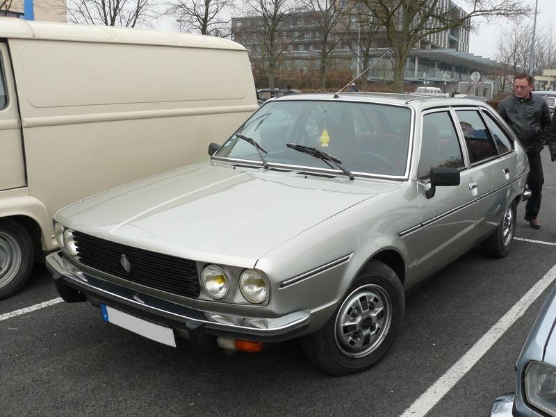 Silver hatchback with quad headlights and chrome details.