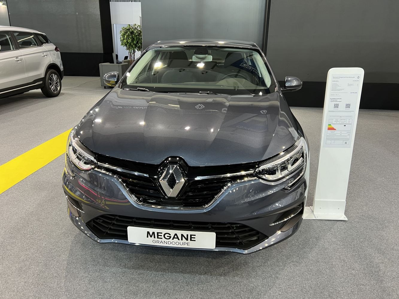 Front view of a sedan with distinctive grille and LED headlights