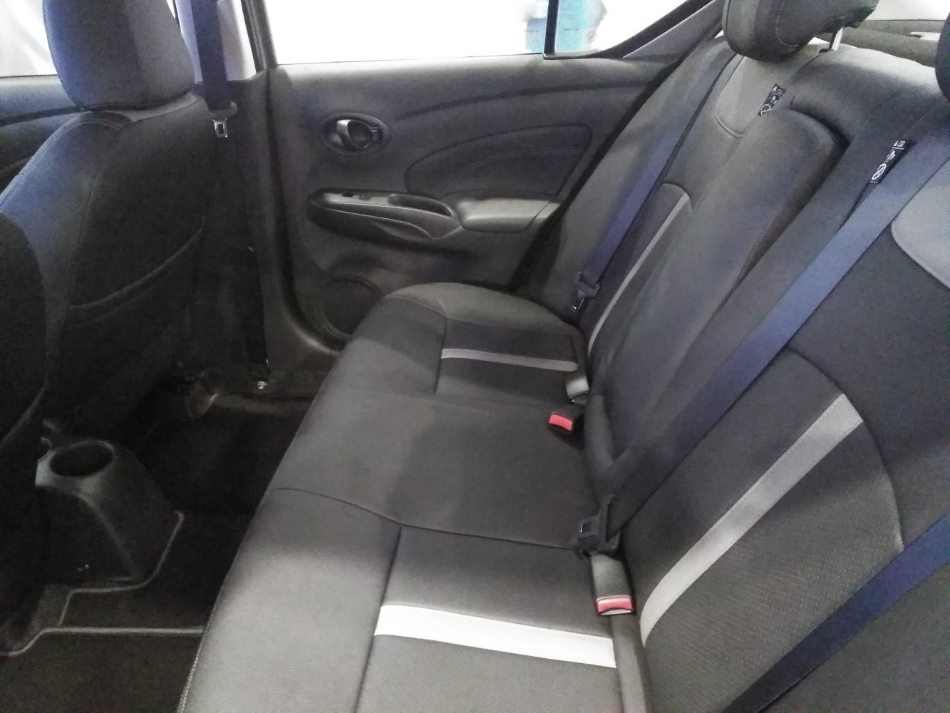 Rear seat interior with fabric upholstery and seat belts