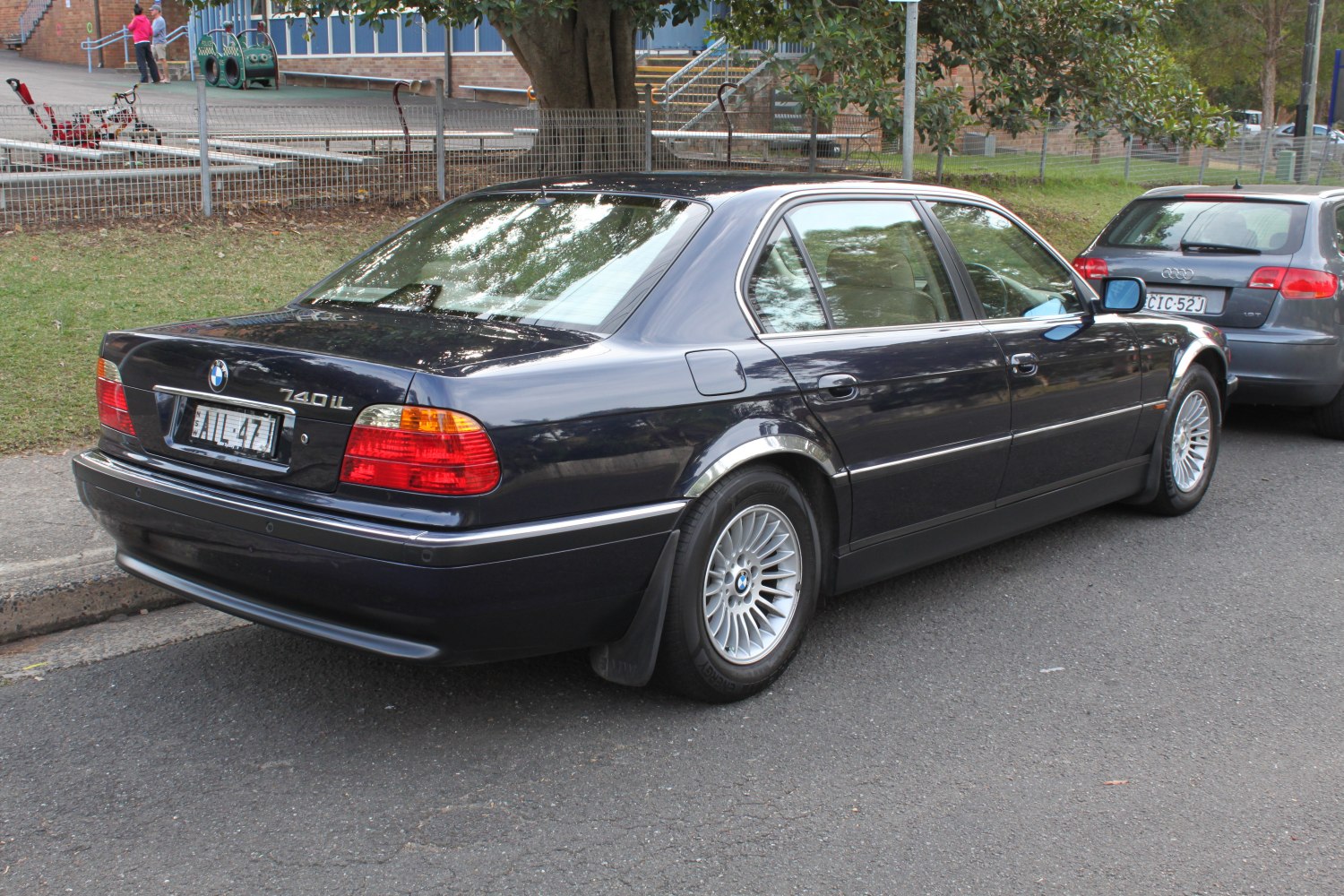 Rear side view of classic long-wheelbase sedan with alloy wheels and taillights