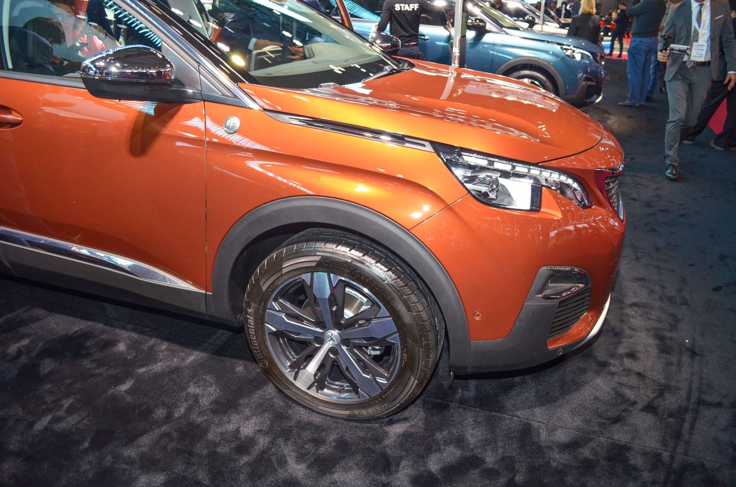 Front side view with alloy wheel and headlight of a modern SUV