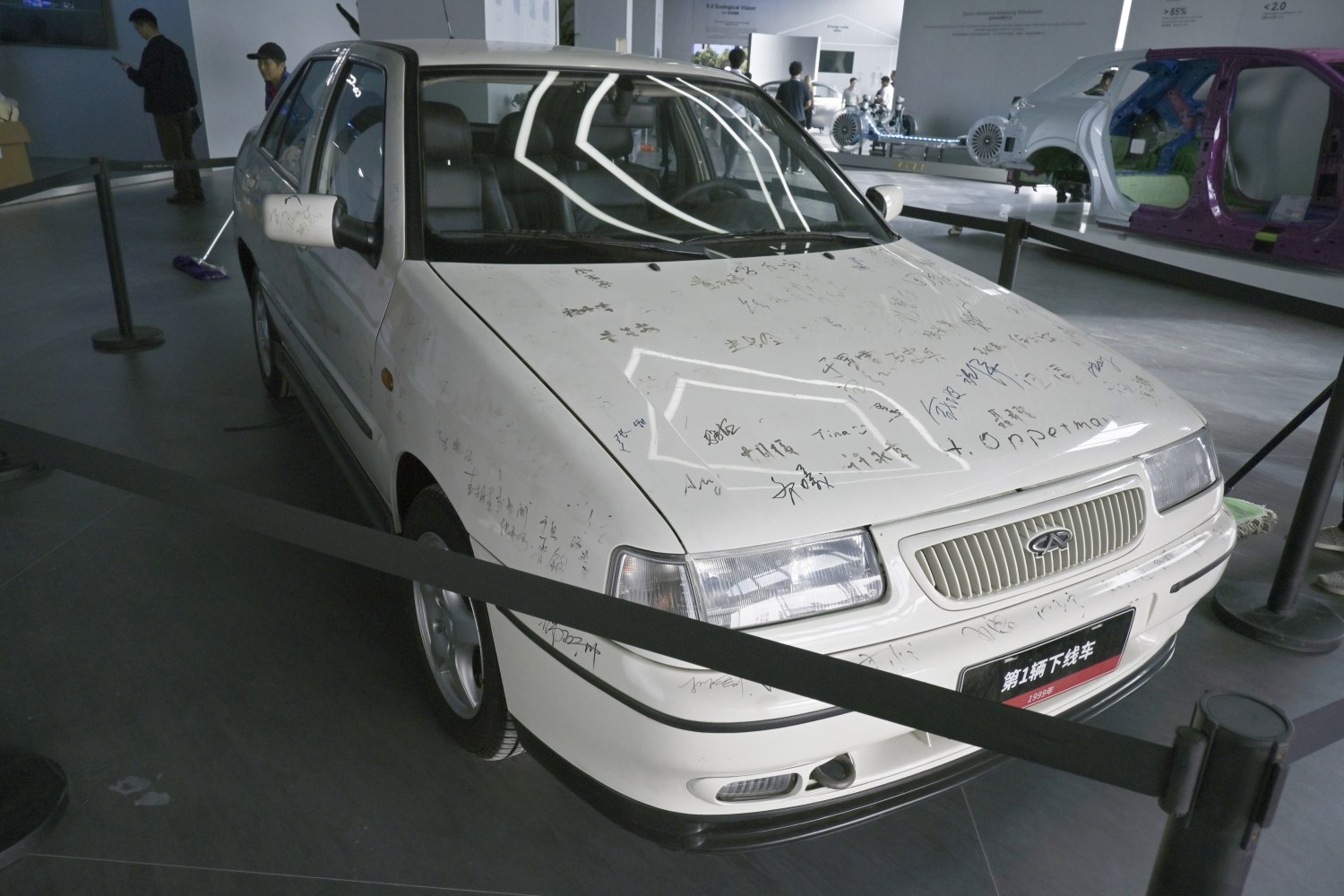 White sedan with autographs, front grille, rectangular headlights