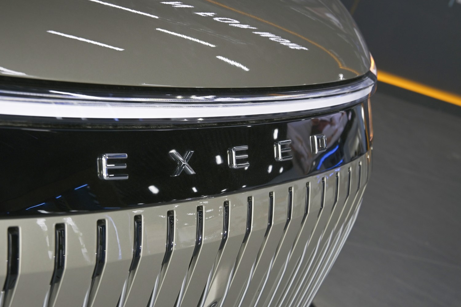 Close-up of front grille with vertical slats and LED light strip