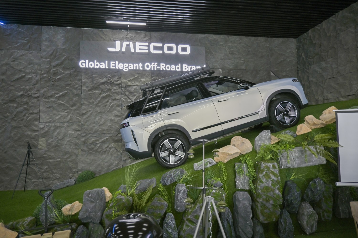 SUV climbing rocky incline with roof rack and ladder