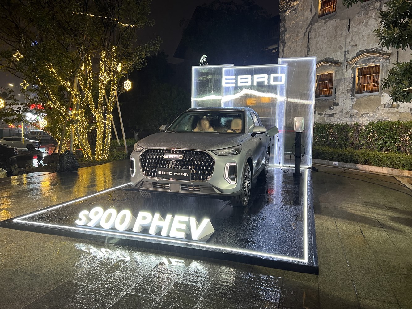 Front view of SUV with illuminated grille and LED headlights at night.