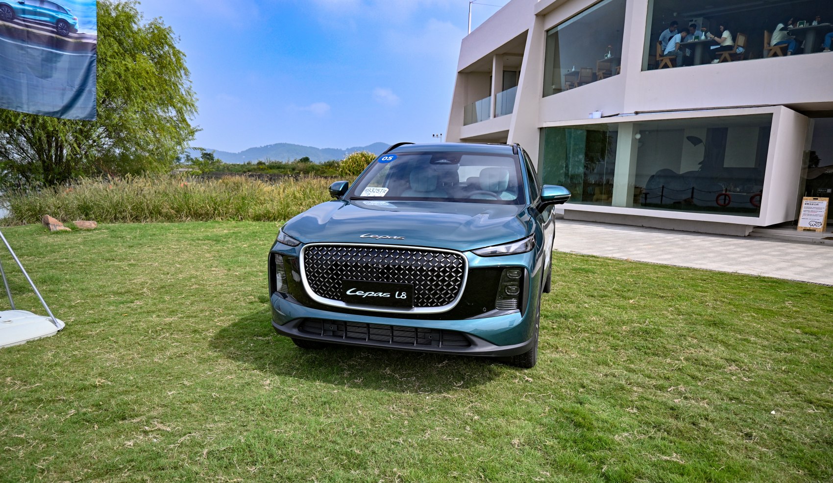 Front view with large mesh grille and vertical LED headlights