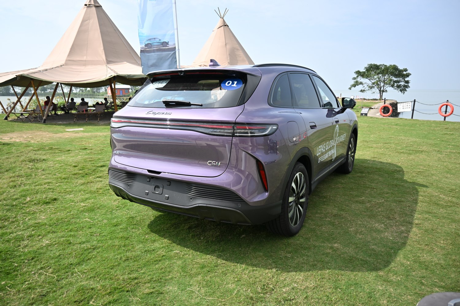 Sleek horizontal tail lights and smooth rear design of an SUV.