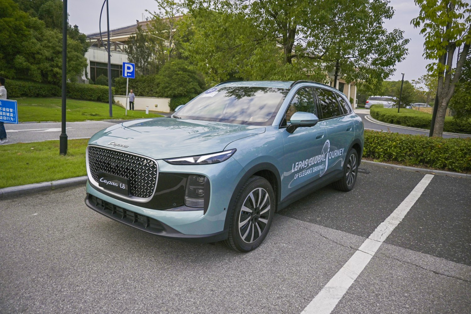 Modern SUV with large diamond pattern grille and slim LED headlights