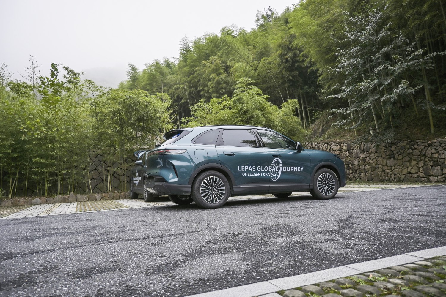 Side profile of 2026 SUV with alloy wheels on mountain road