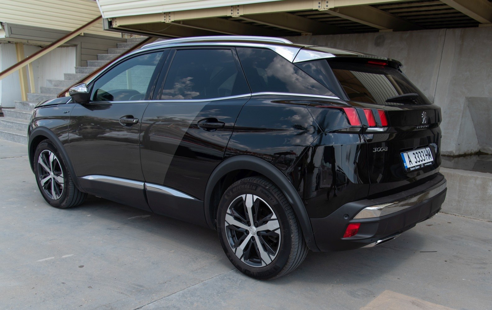 Rear and side view of a black SUV with distinctive tail lights and alloy wheels