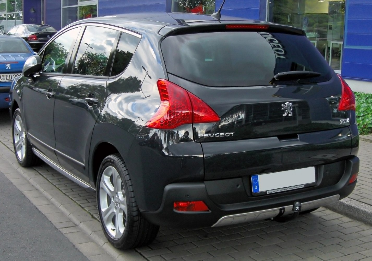 Rear view showing distinctive taillights and rear windshield with wiper