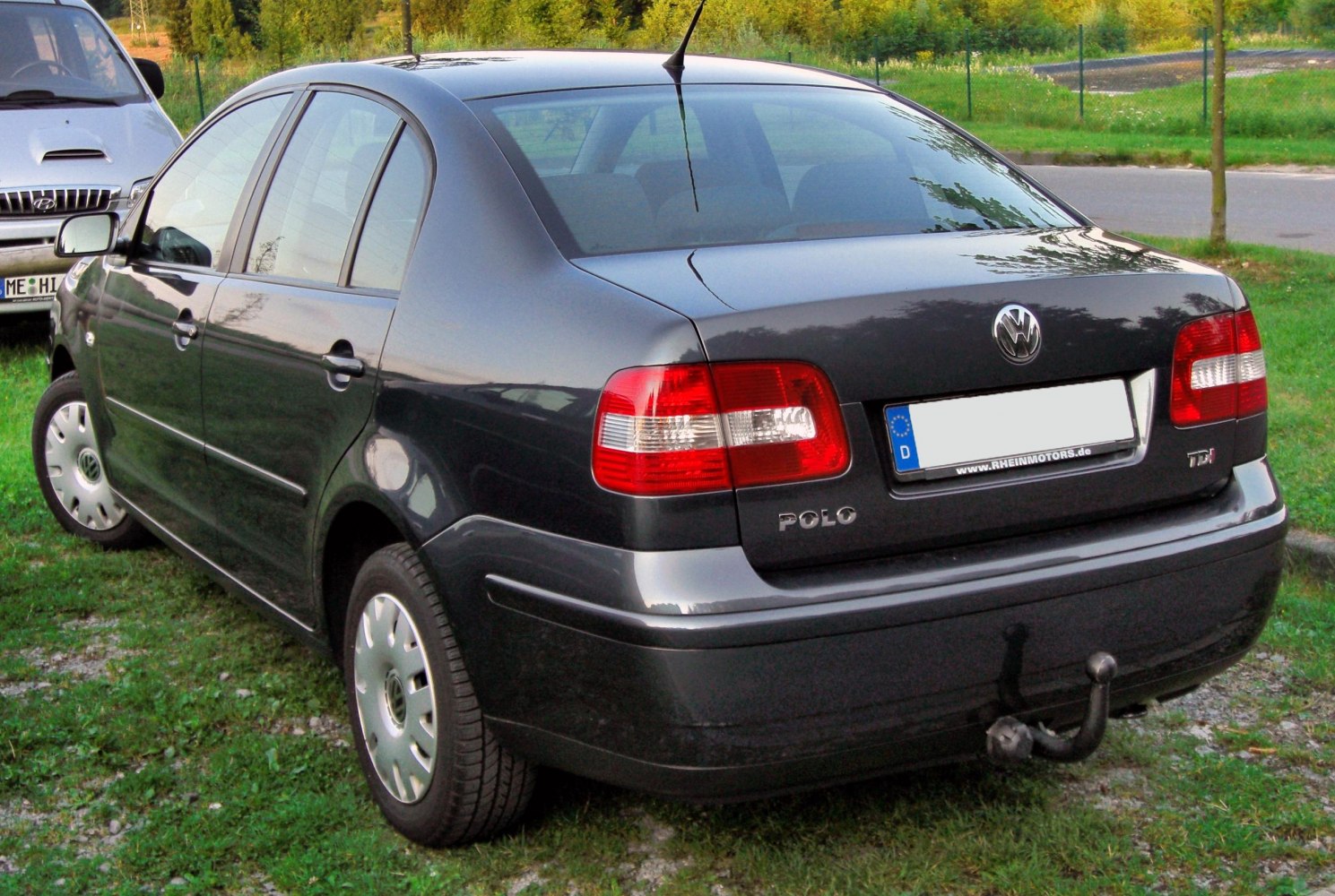Rear view of compact sedan with distinct tail lights and tow hook
