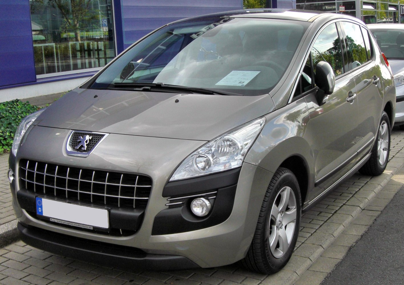 Front view with prominent grille, headlights, and fog lights