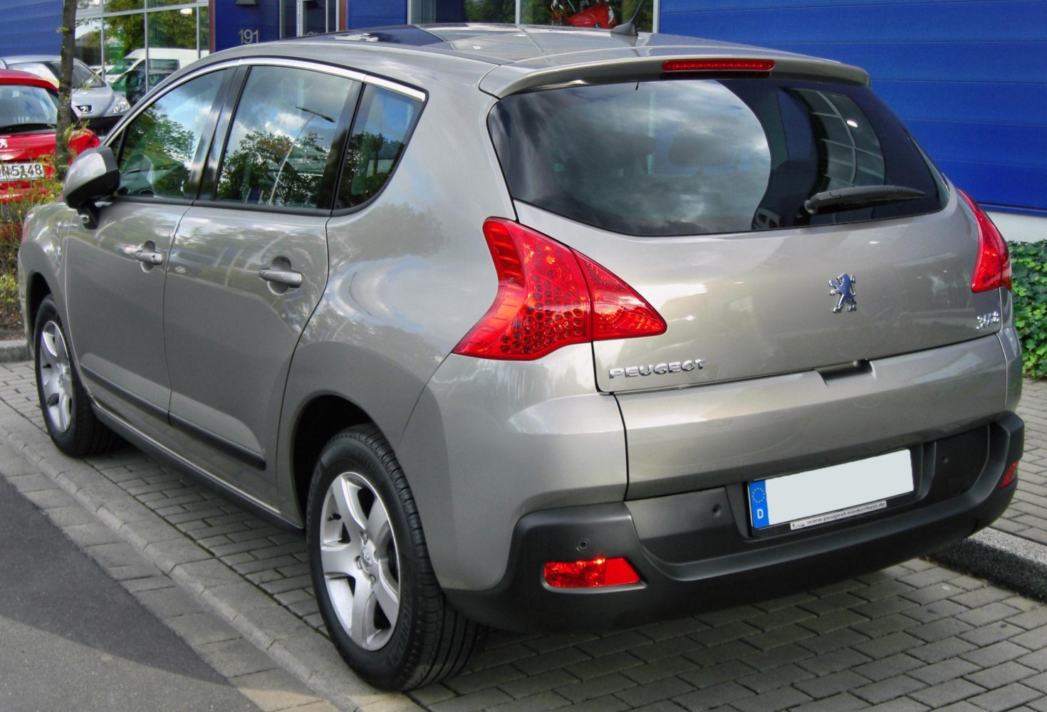Rear side view with distinctive tail lights and hatchback design