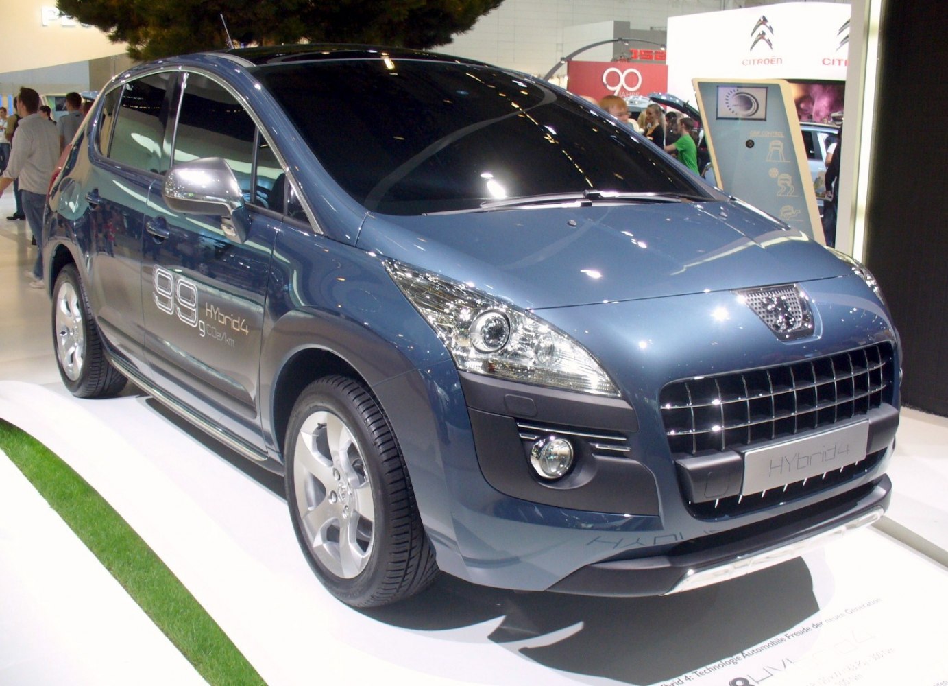 Front side view of hybrid SUV with detailed headlights and grille
