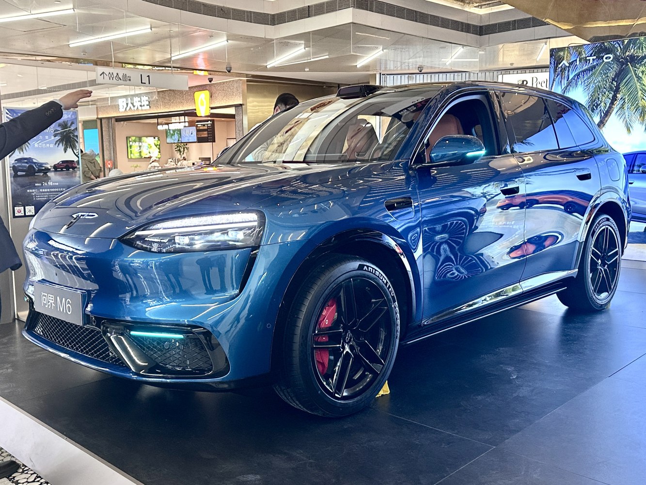 LED headlights and sporty black wheels with red brake calipers on a sleek electric SUV.