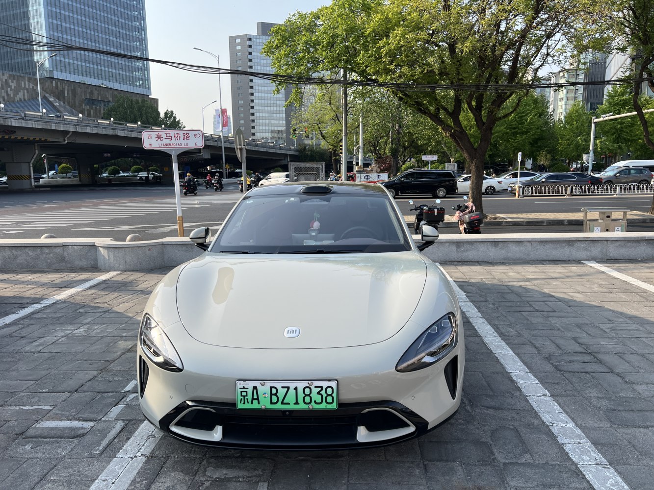 Front view of an electric coupe with aerodynamic design and sleek headlights
