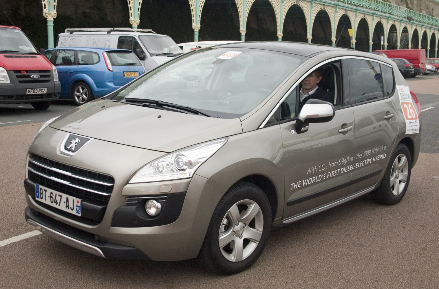 Front-side view of hybrid diesel vehicle with distinct headlights and grille