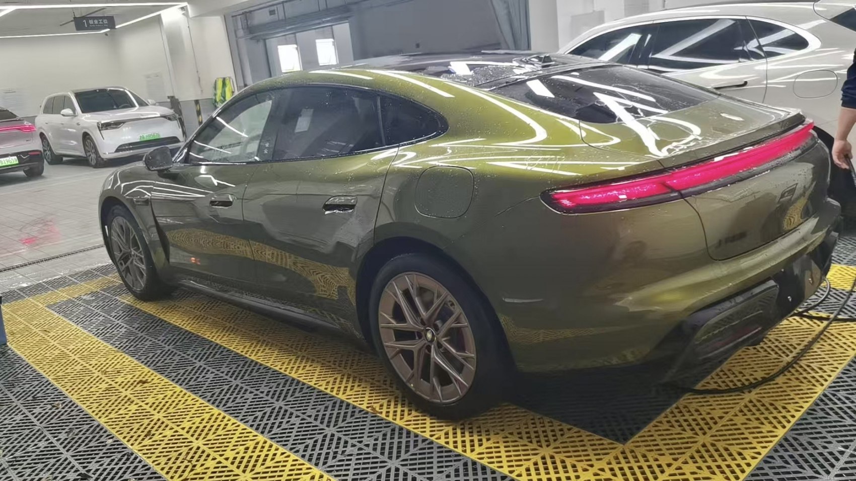 Sleek rear side view with modern alloy wheels and full-width tail light