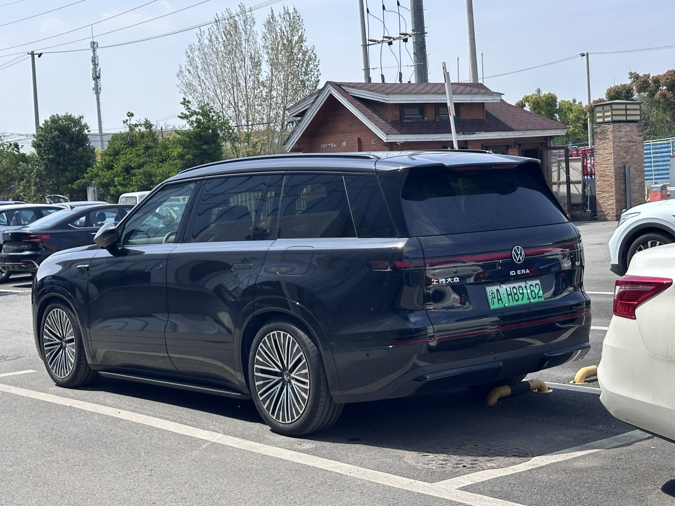 Rear and side view of vehicle with continuous taillight strip and stylish alloy wheels.