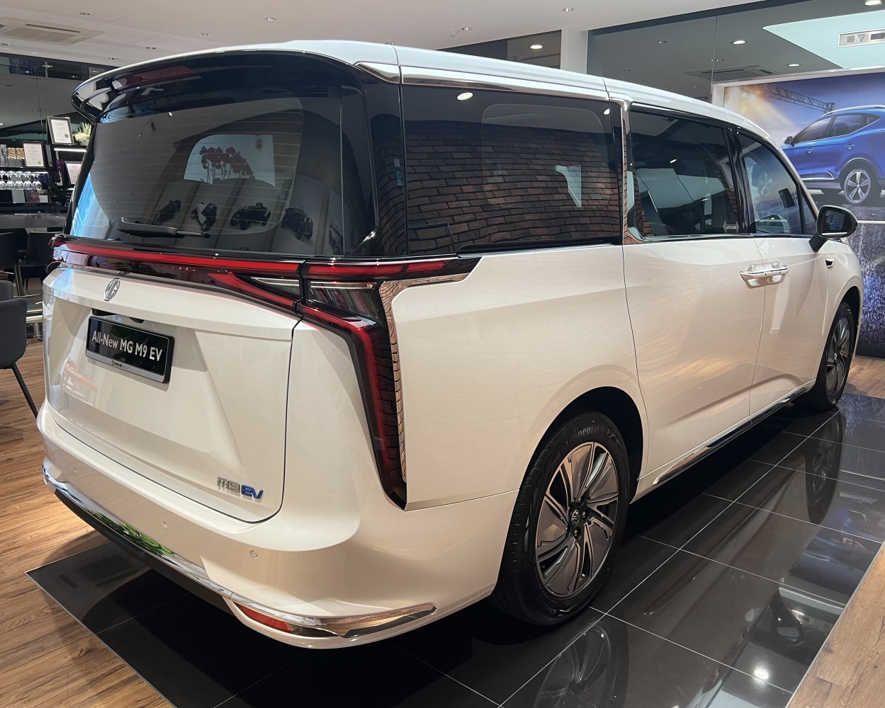 Rear and side view of a modern electric MPV with unique taillights.