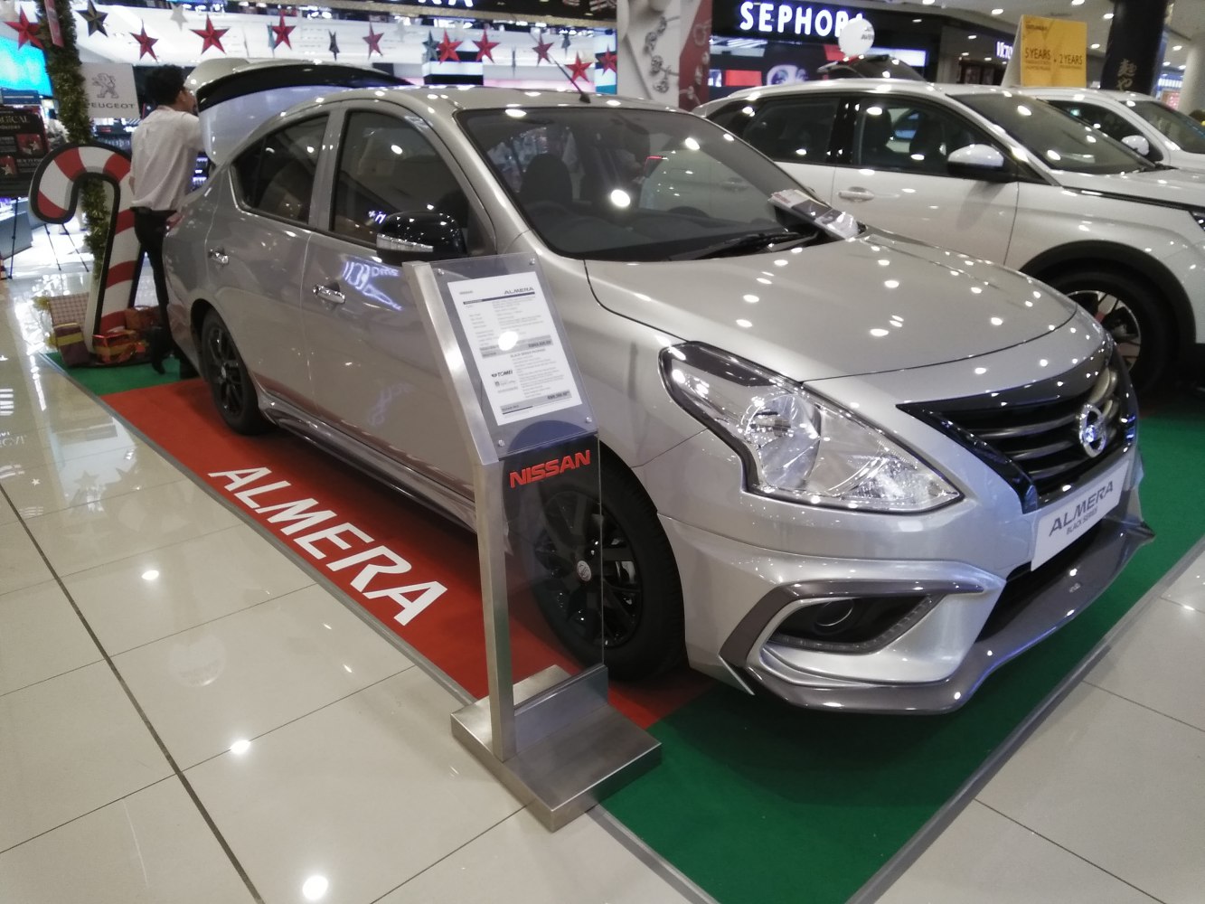 Silver sedan with modern front fascia and showroom display