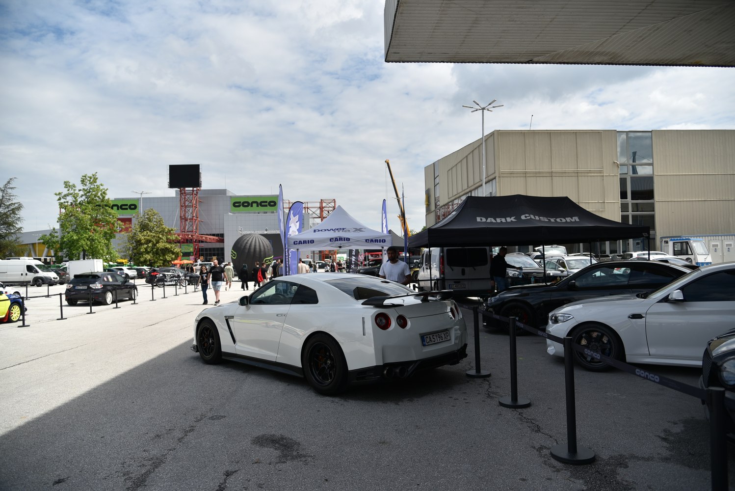 White sports coupe with rear spoiler and round taillights