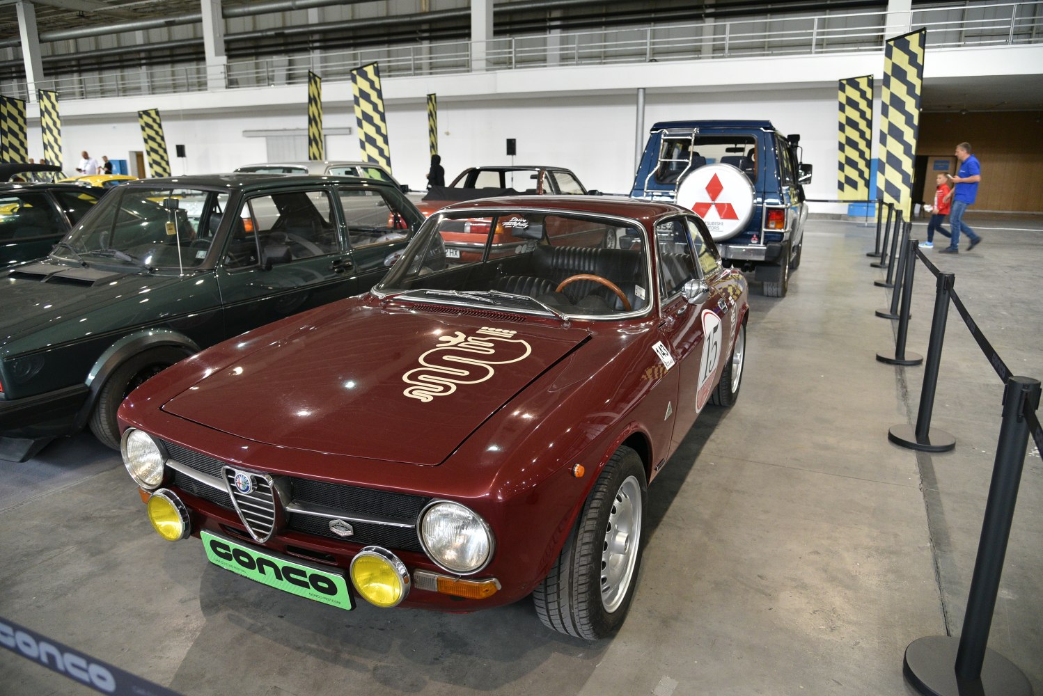 Front view of vintage sports coupe with round headlights and racing decals