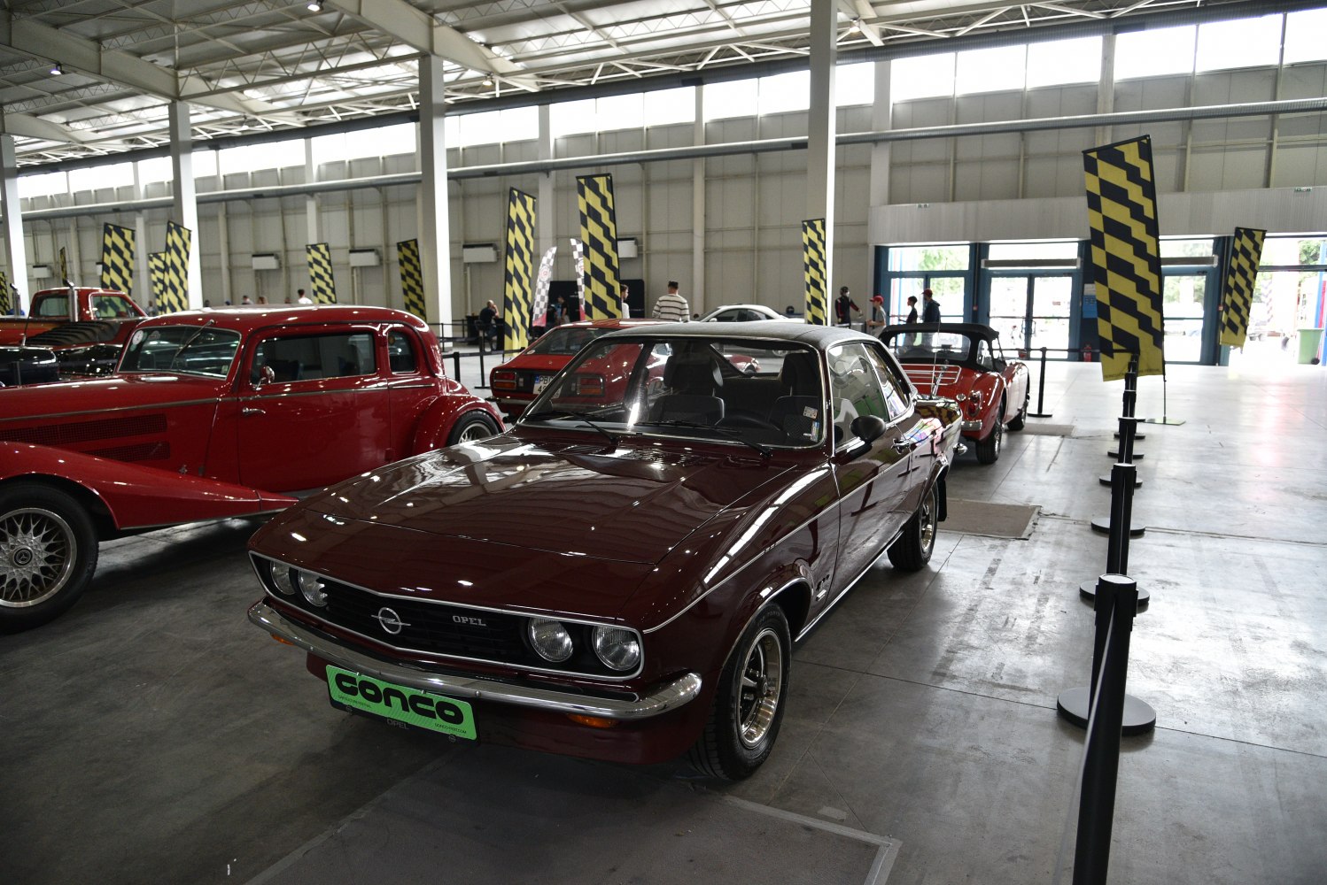 Vintage sports coupe with round headlights and black grille.