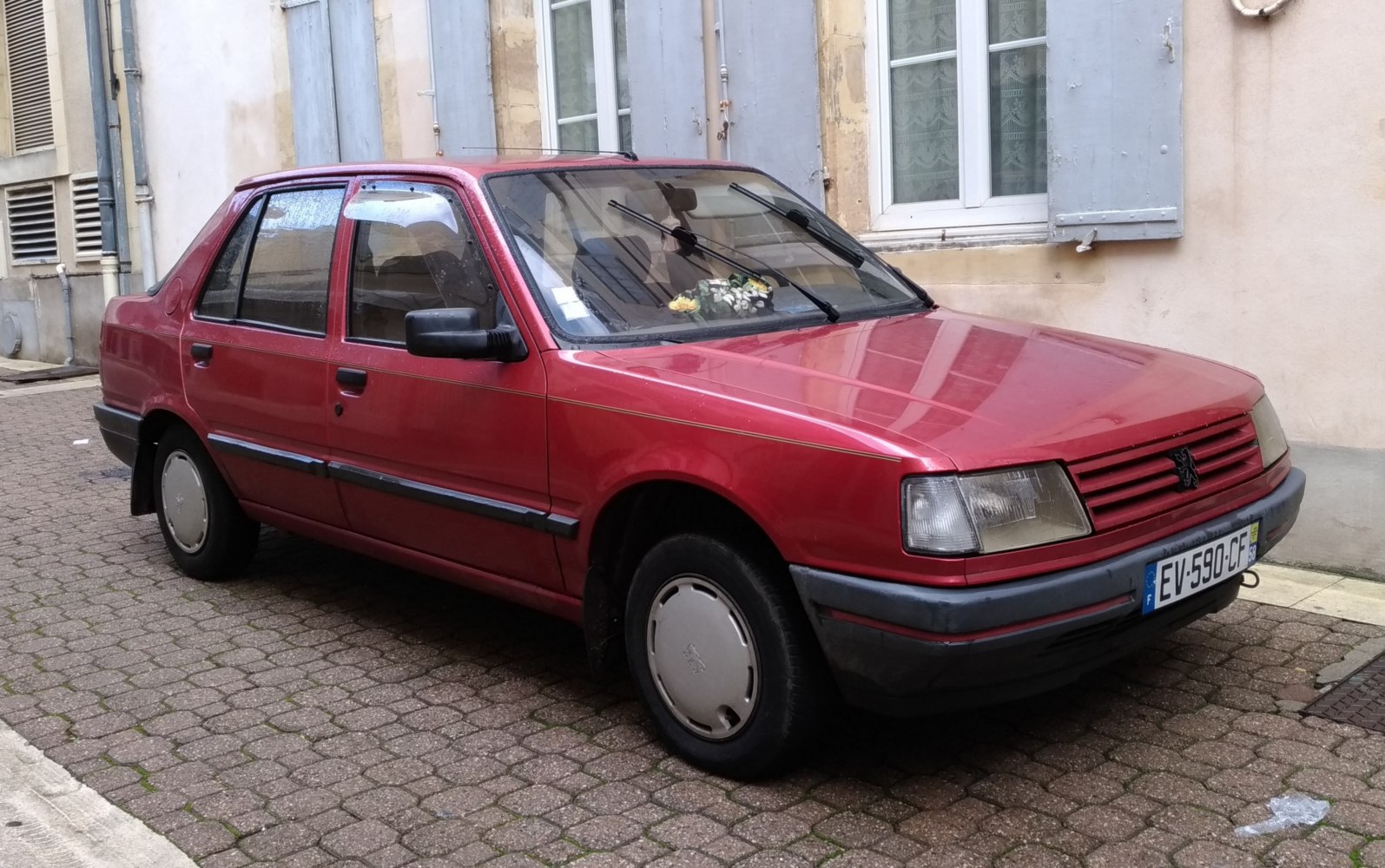 Front-angle view of vintage sedan with classic headlight and hood design