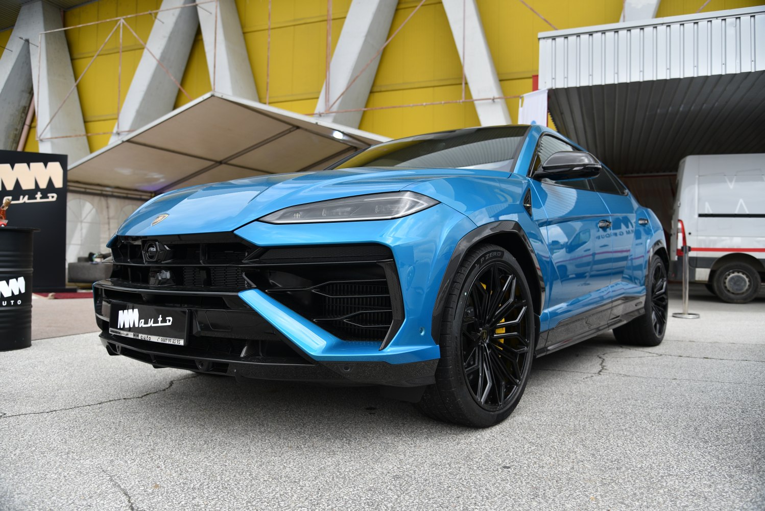 Blue SUV front with sleek headlights and black alloy wheels