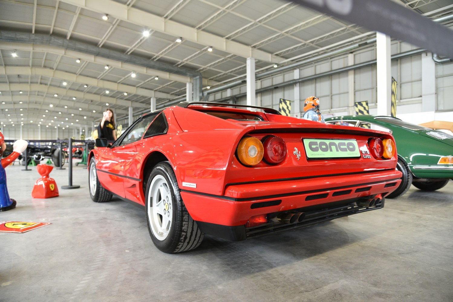 Rear view of classic sports car with distinctive taillights and exhaust.