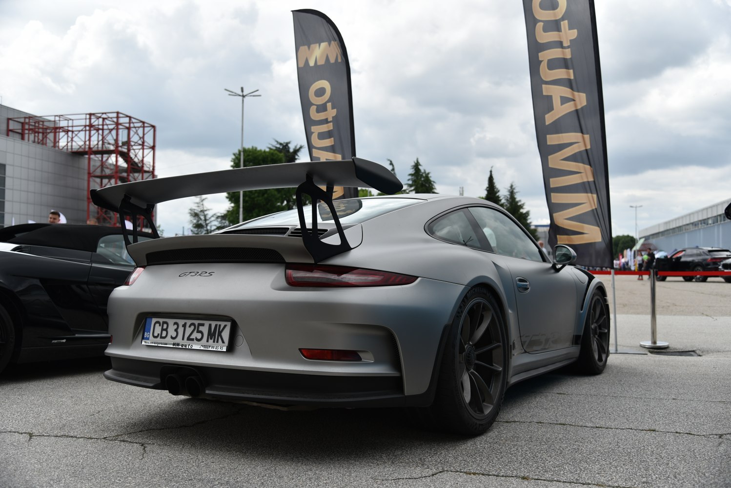 Rear view with large fixed spoiler and wide body design
