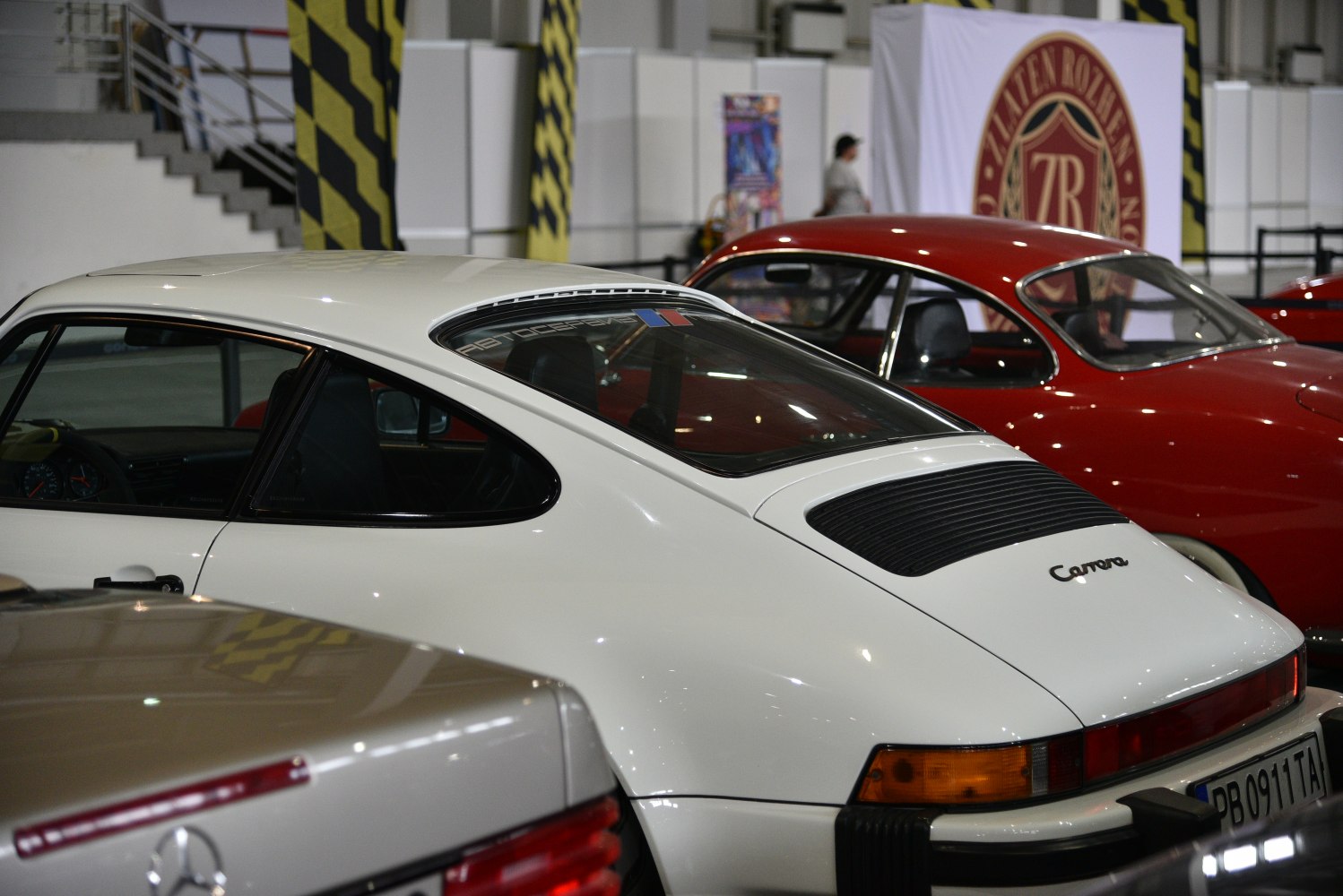 Rear and side view of classic coupe with sloping rear window and Carrera badge
