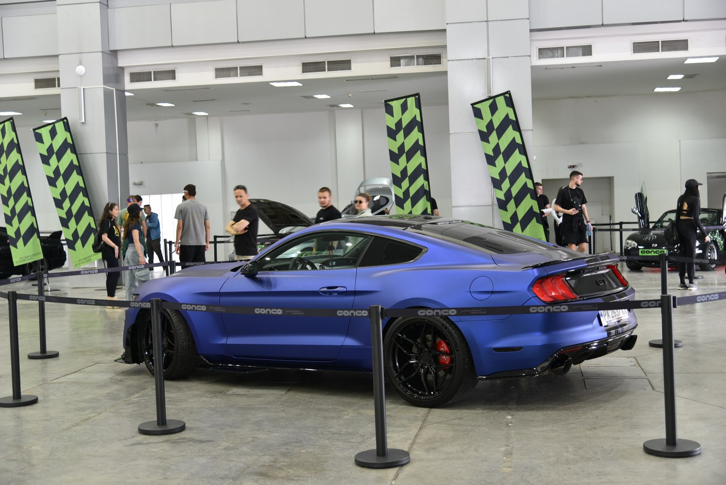 Matte blue two-door coupe with black rims and red brake calipers