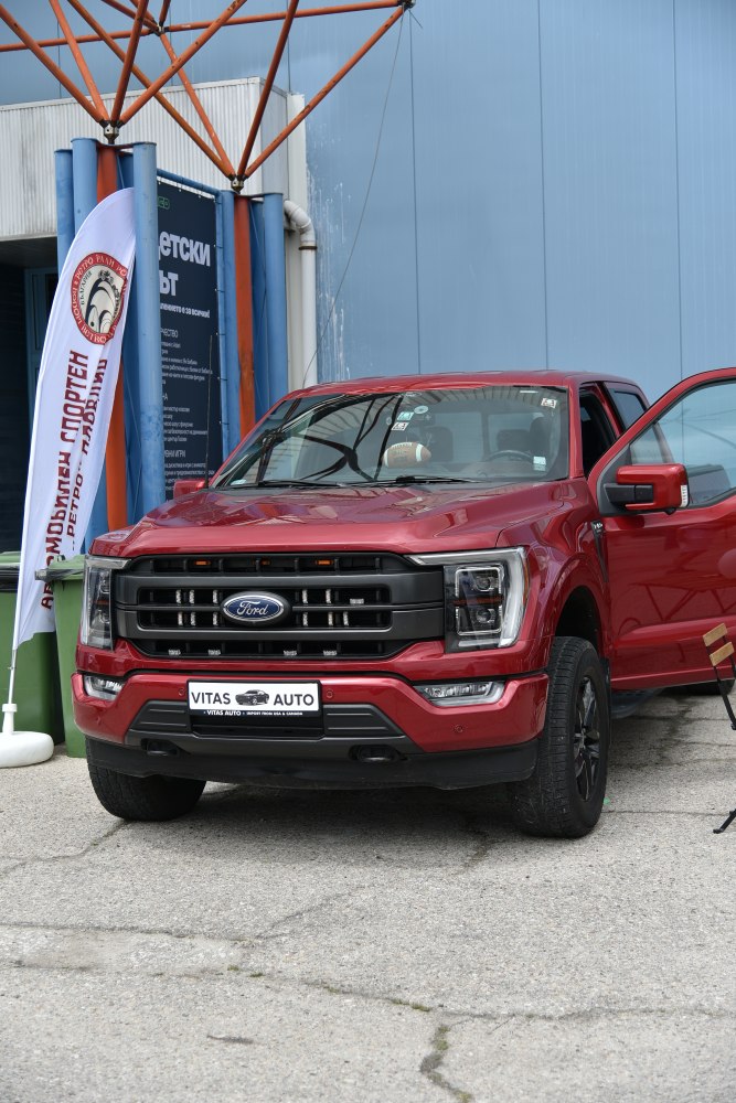 Front view of red pickup truck with grille and headlights