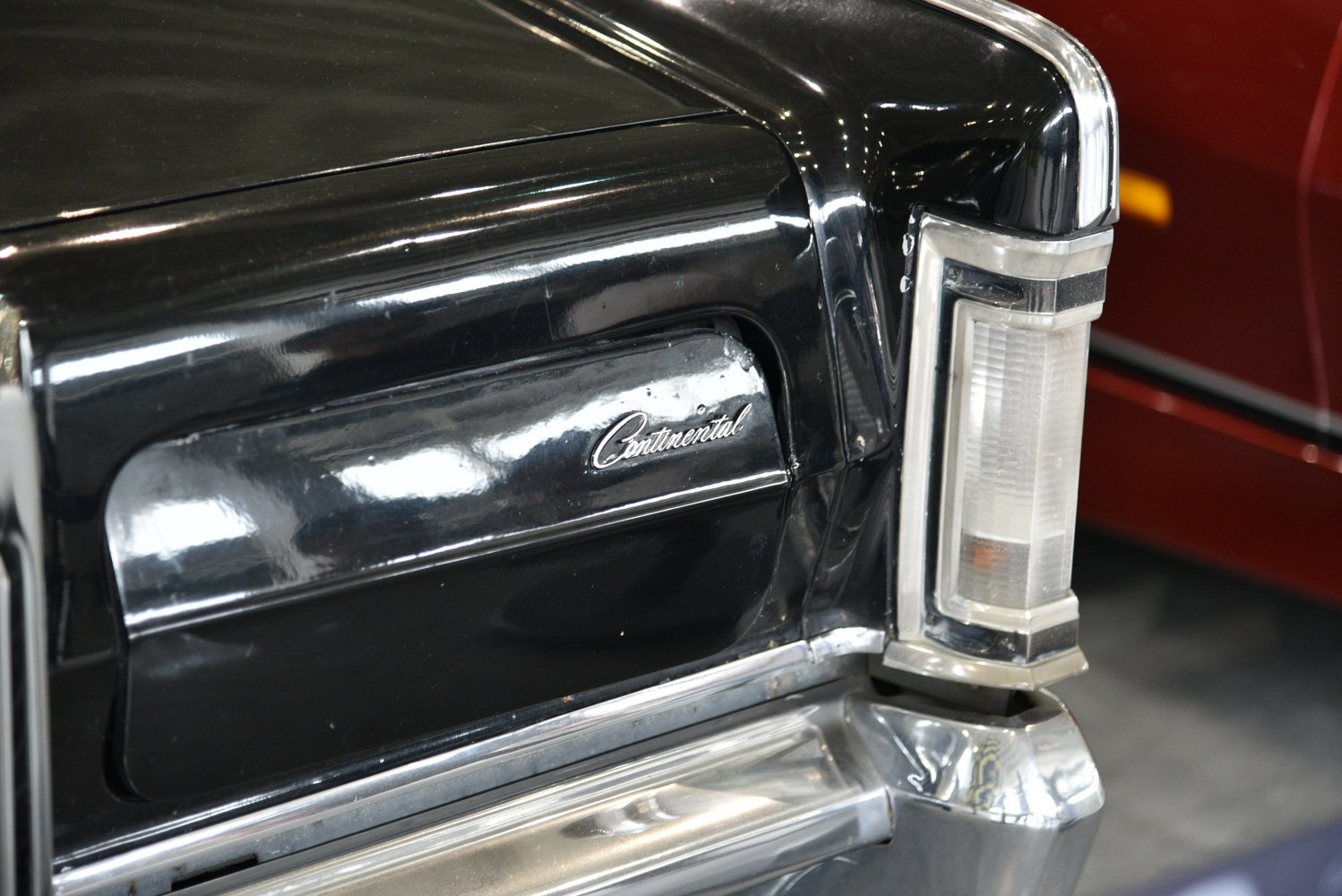 Close-up of rear light and 'Continental' emblem with chrome trim