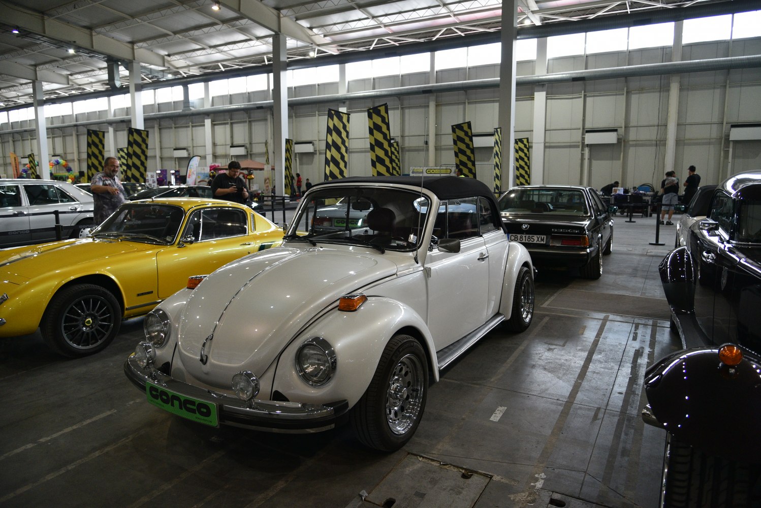 White classic convertible with rounded fenders and chrome rims